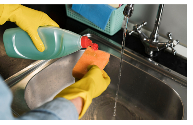 woman-with-rubber-gloves-cleaning-sink.jpg